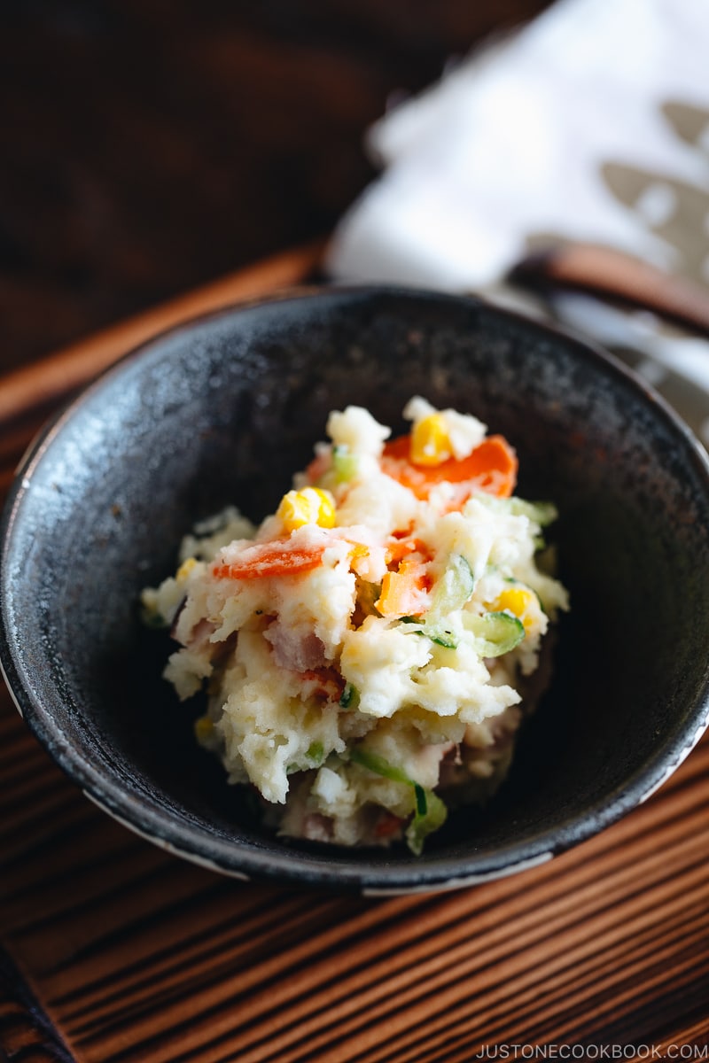 Japanese potato salad in a Japanese black ceramic bowl.