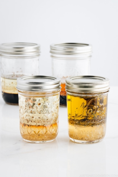 4 Japanese salad dressings in mason jars.