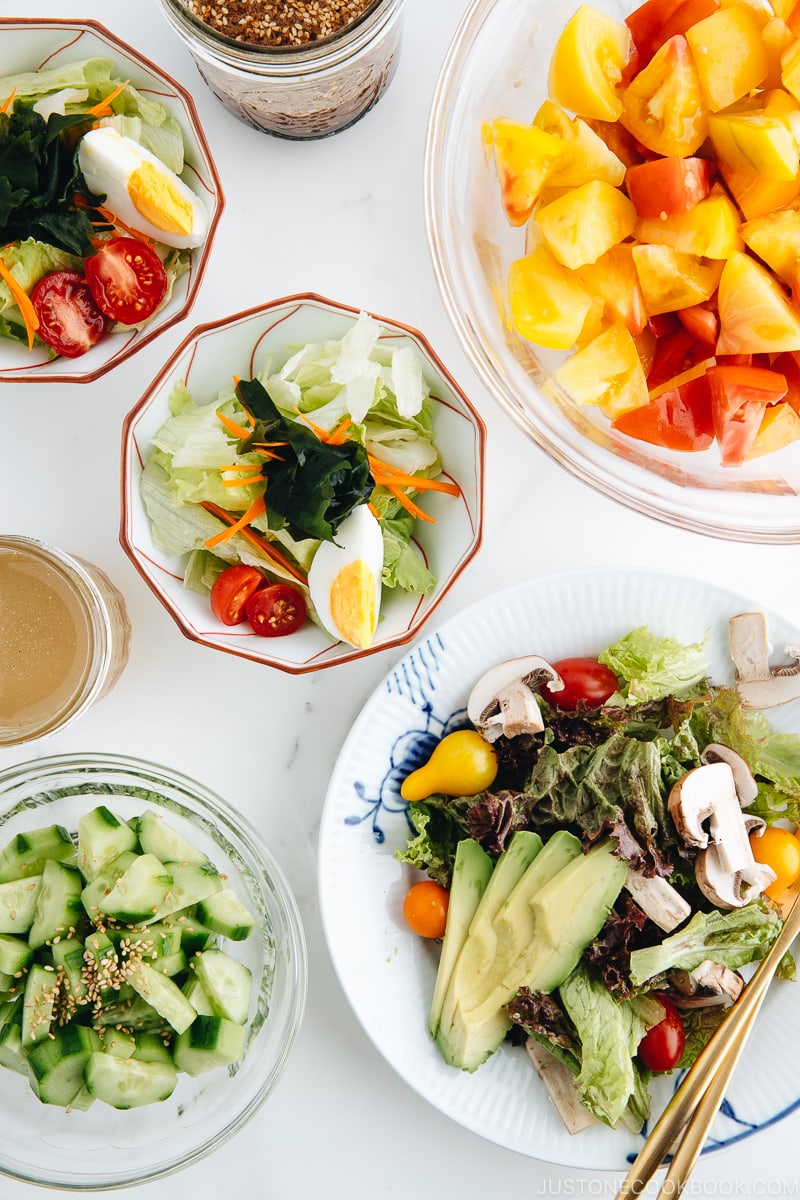 4 kinds of Japanese salads in different bowls and plates.