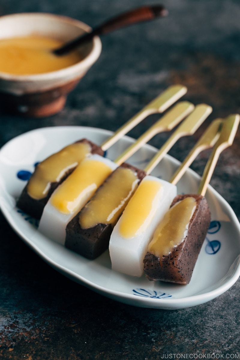 Skewered konnyaku dengaku on a plate.