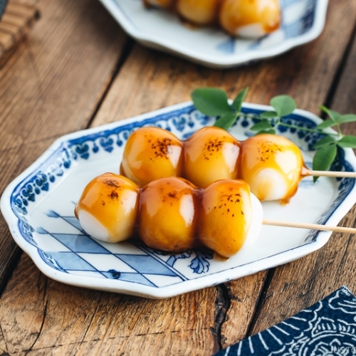 Mitarashi Dango on a blue plate.