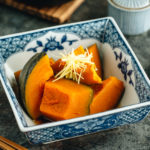 Simmered Kabocha Squash in a Japanese square bowl.