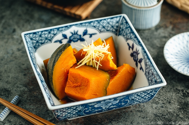 Simmered Kabocha Squash in a Japanese square bowl.