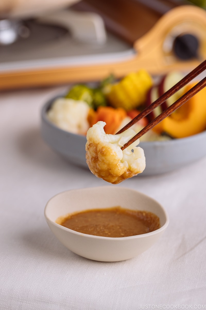 Steamed vegetables with dipping sauce.
