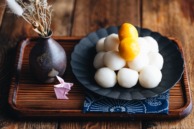 Tsukimi Dango on a black plate.