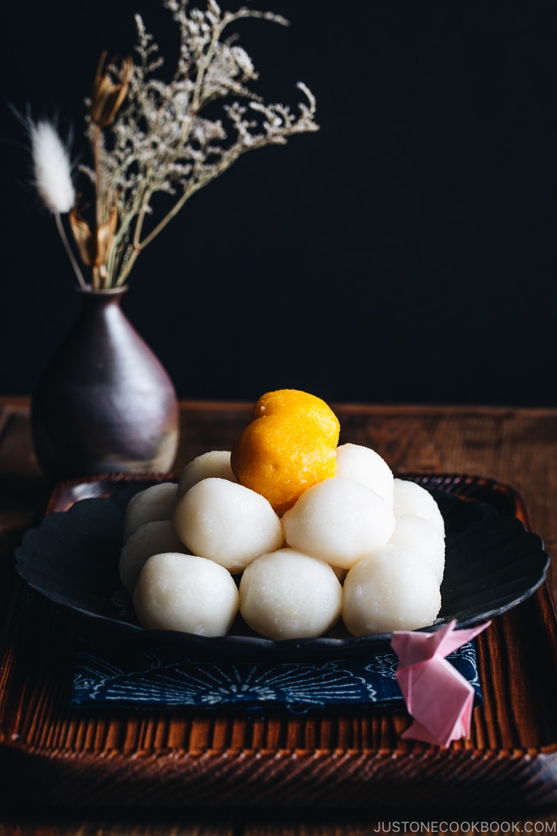 Tsukimi Dango on a black plate.