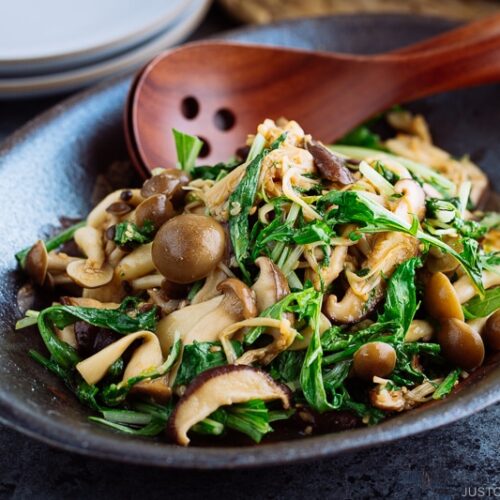 Warm Mushroom Salad with Sesame Dressing in a dark ceramic bowl.