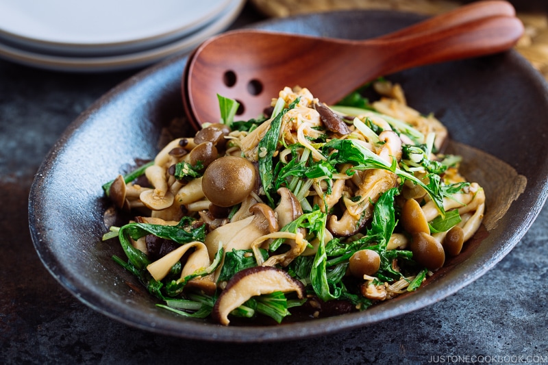 Warm Mushroom Salad with Sesame Dressing in a dark ceramic bowl.