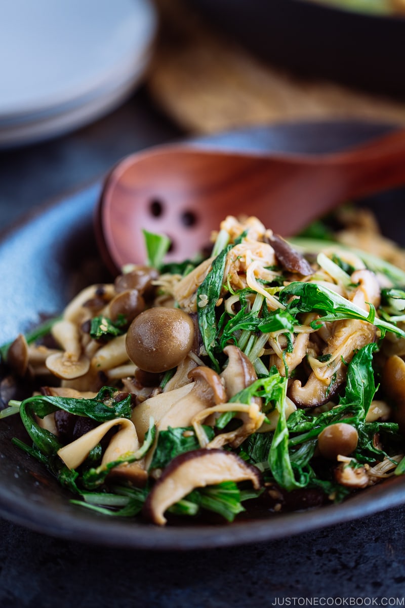 Warm Mushroom Salad with Sesame Dressing in a dark ceramic bowl.