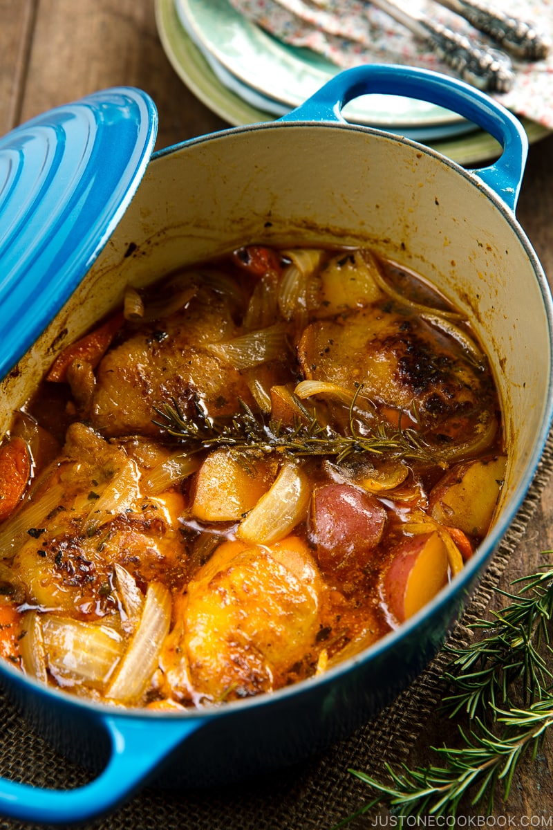 Dutch oven containing braised chicken and vegetables.