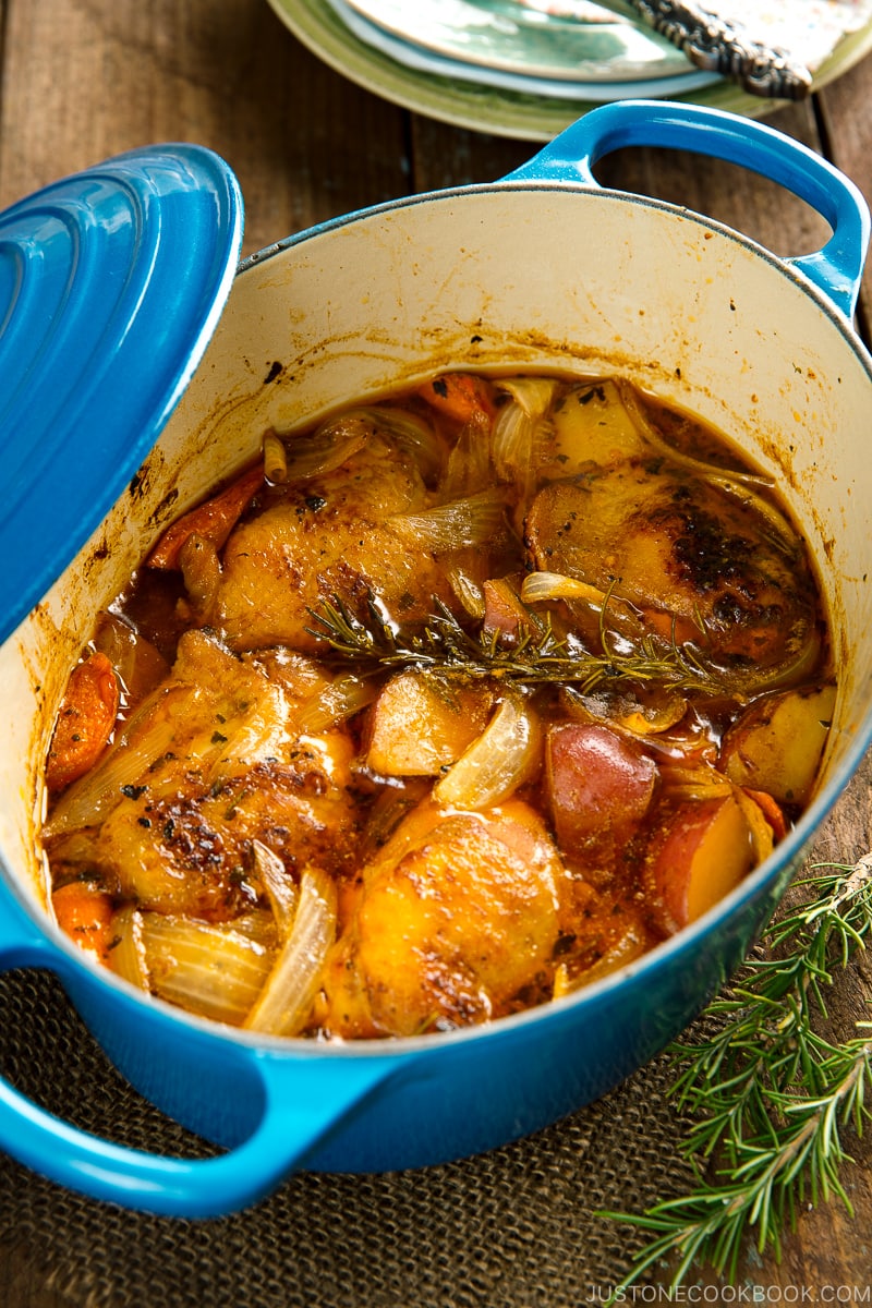 Dutch oven containing braised chicken and vegetables.