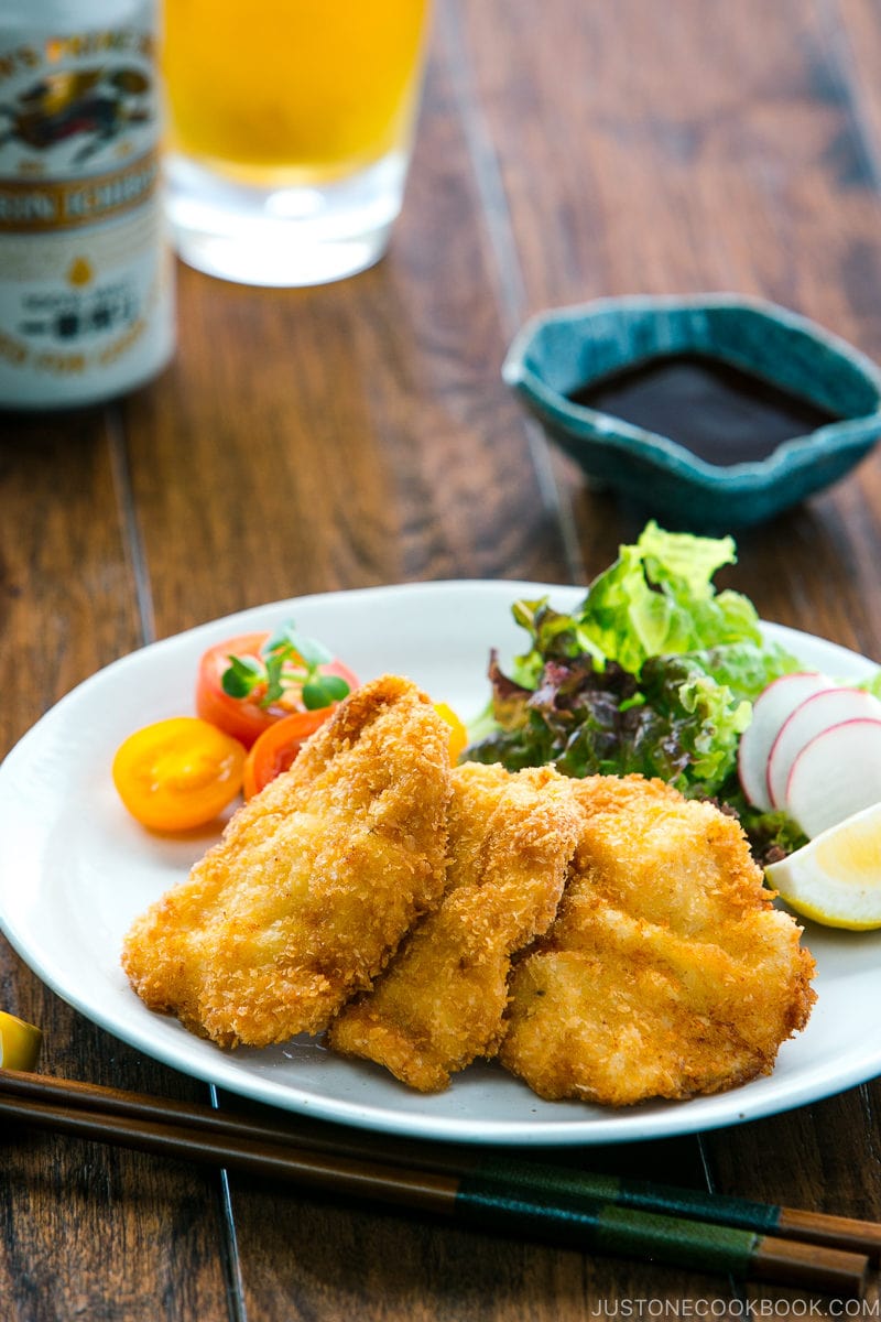 Chicken katsu served on a plate along with spring salad.