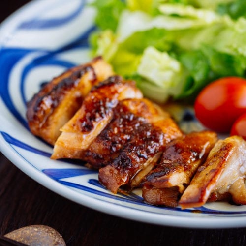 Chicken teriyaki served with salad on a plate.