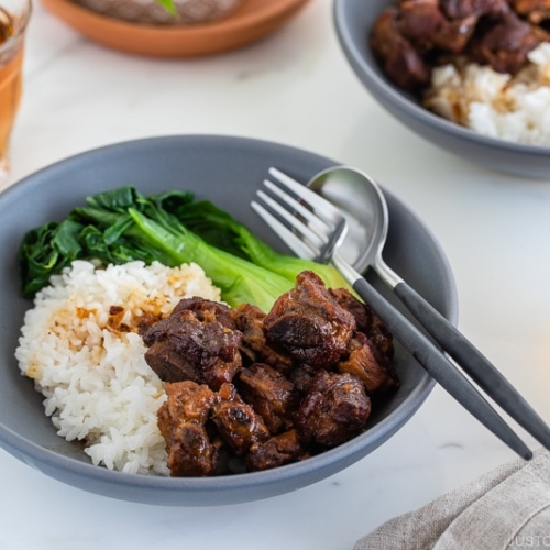 Instant pot honey spare ribs served with rice and steamed bok choy in a grey ceramic bowl.