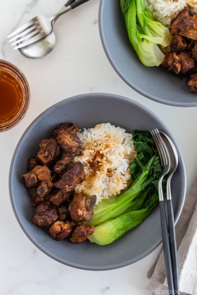 Instant pot honey spare ribs served with rice and steamed bok choy in a grey ceramic bowl.