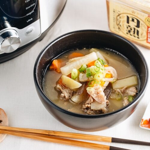 Tonjiru served in a black bowl.