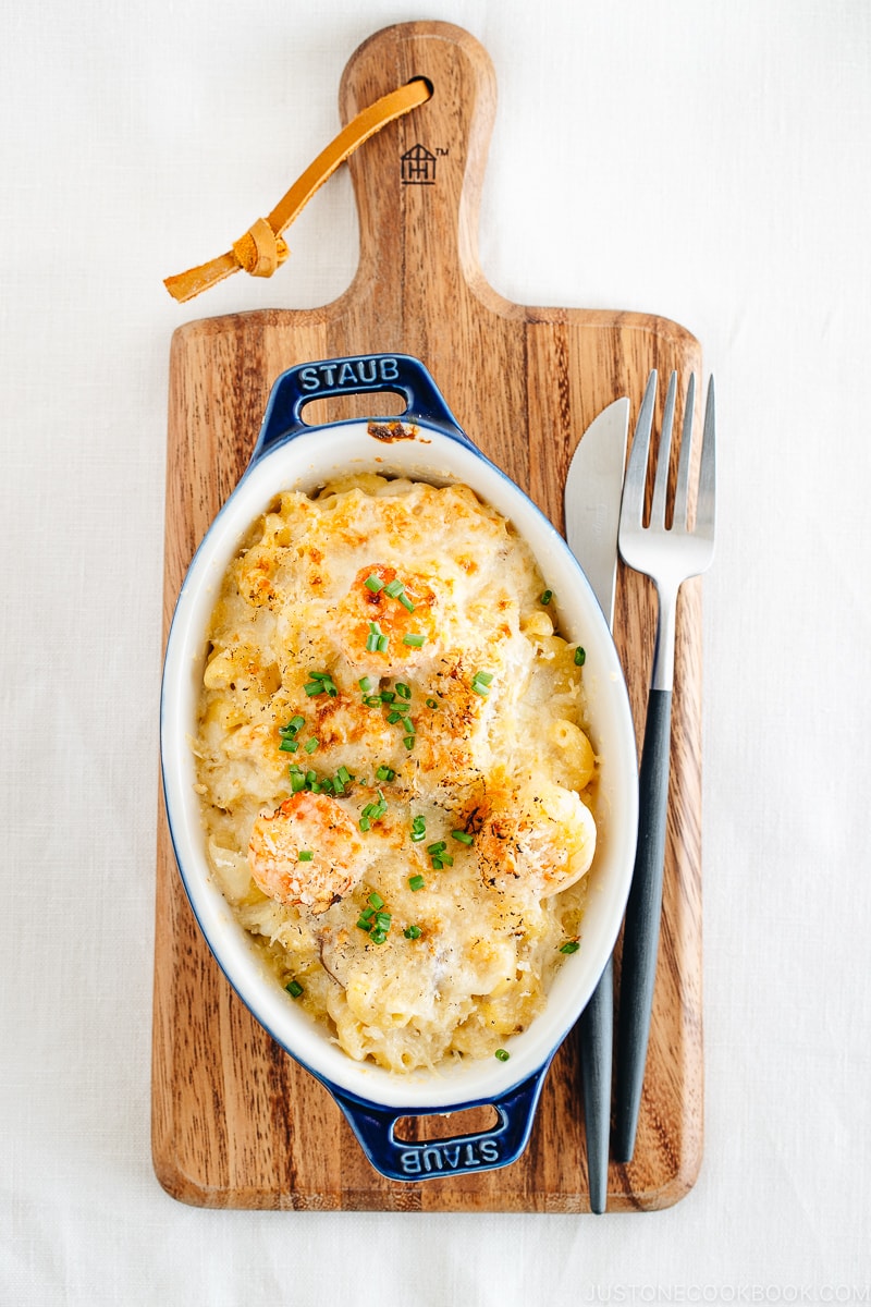 Creamy macaroni gratin in a blue STAUB gratin dish.