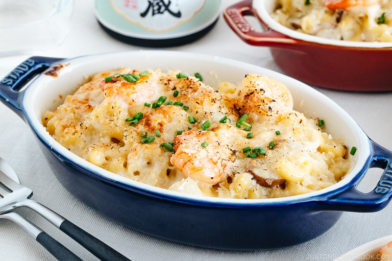 Creamy macaroni gratin in a blue STAUB gratin dish.