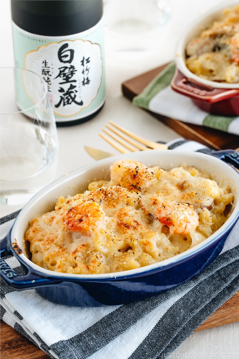 Creamy macaroni gratin in a blue STAUB gratin dish.