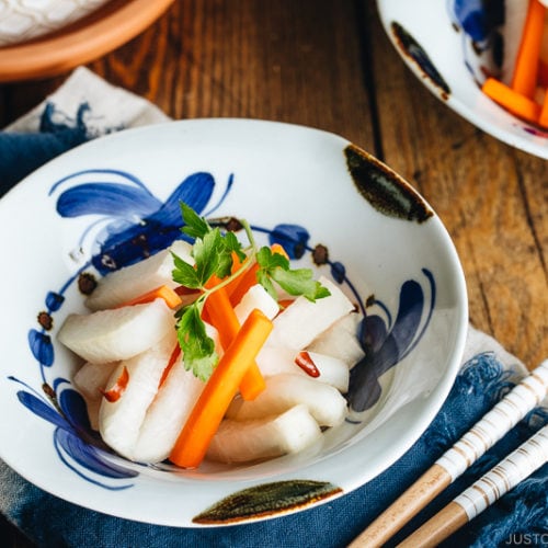 Daikon and carrot pickled in sweet vinegar, served in Japanese ceramic bowls.