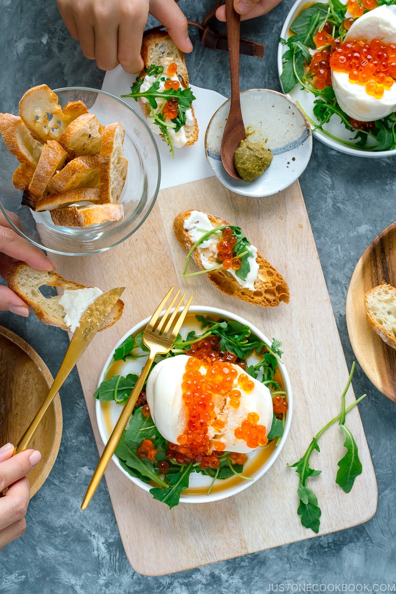 Japanese twist on Burrata Crostini served with ikura and arugula.