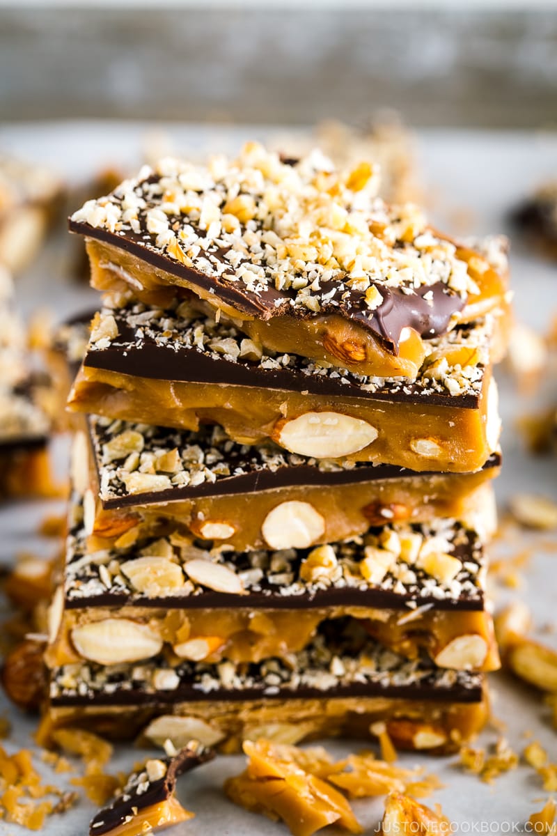 Chocolate Almond Toffee stacked high on a baking sheet.