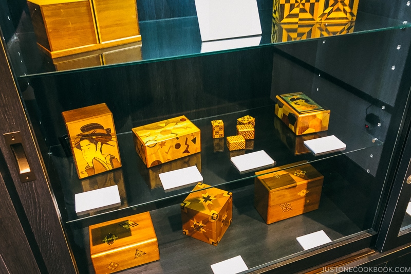 Japanese wooden puzzle boxes on a shelf