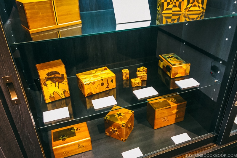 Japanese wooden puzzle boxes on a shelf