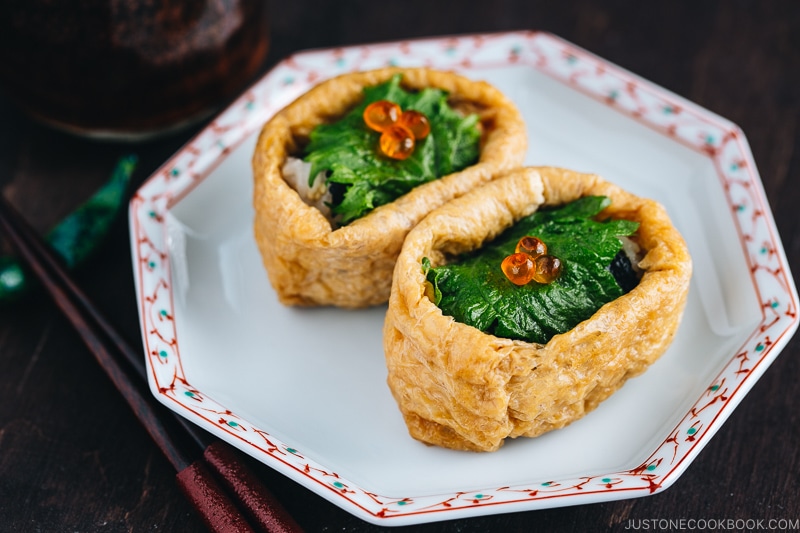 Inari Sushi served on a red and white plate.