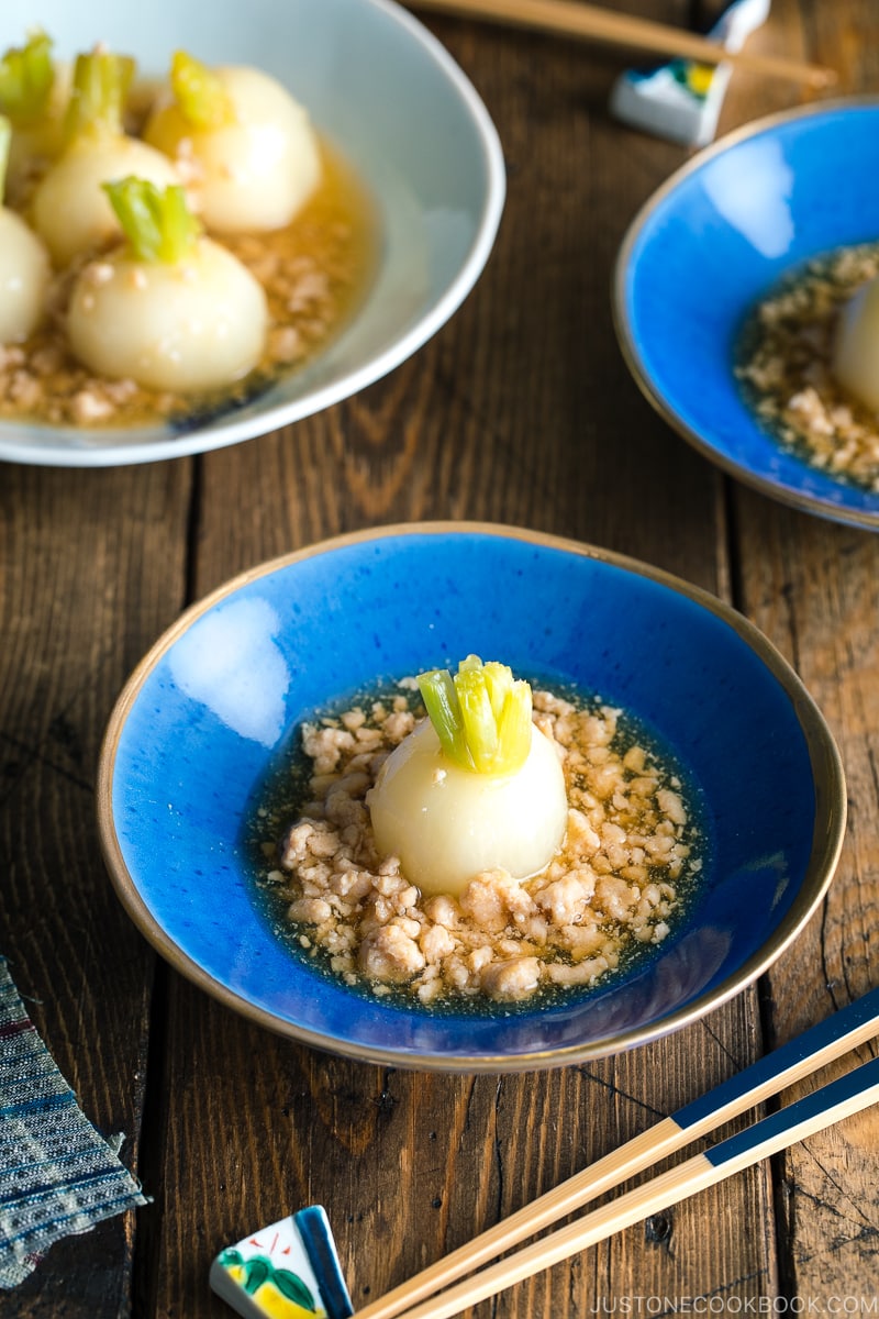 A beautiful Japanese bowl containing simmered Japanese turnips sitting on the thick minced chicken sauce.