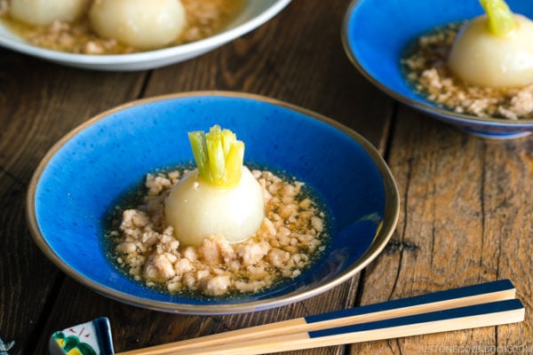 A beautiful Japanese bowl containing simmered Japanese turnips sitting on the thick minced chicken sauce.