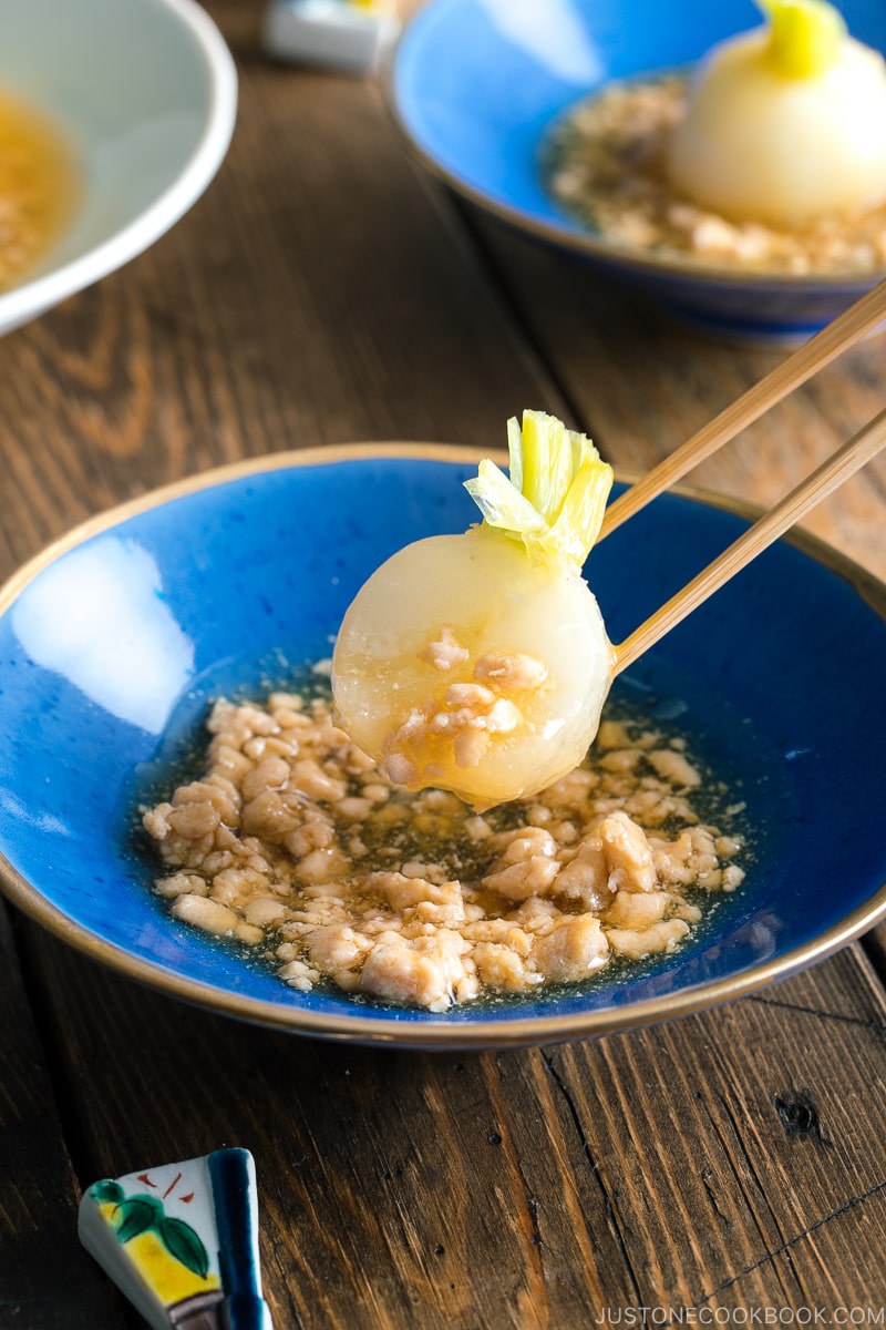 A beautiful Japanese bowl containing simmered Japanese turnips sitting on the thick minced chicken sauce.