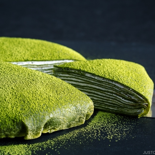 Matcha Mille Crepe Cake served on a black board.