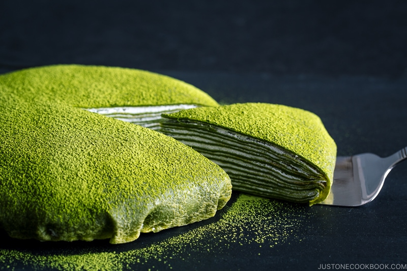 Matcha Mille Crepe Cake served on a black board.