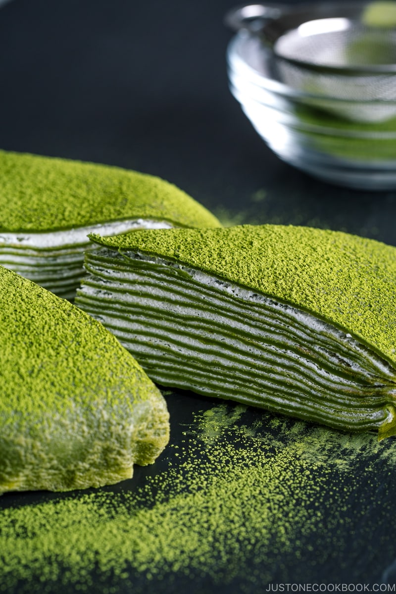 Matcha Mille Crepe Cake served on a black board.