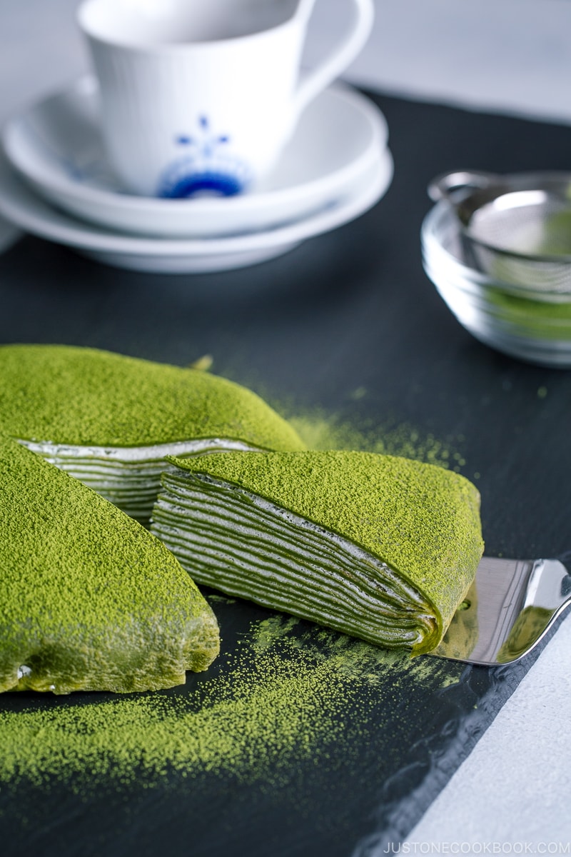 Matcha Mille Crepe Cake served on a black board.