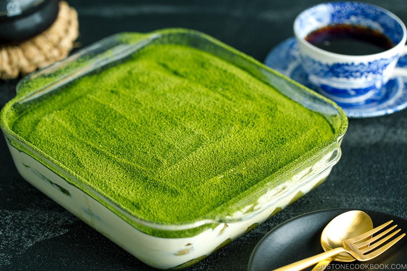 matcha tiramisu cake made with soaked ladyfingers and mascarpone custard filling.