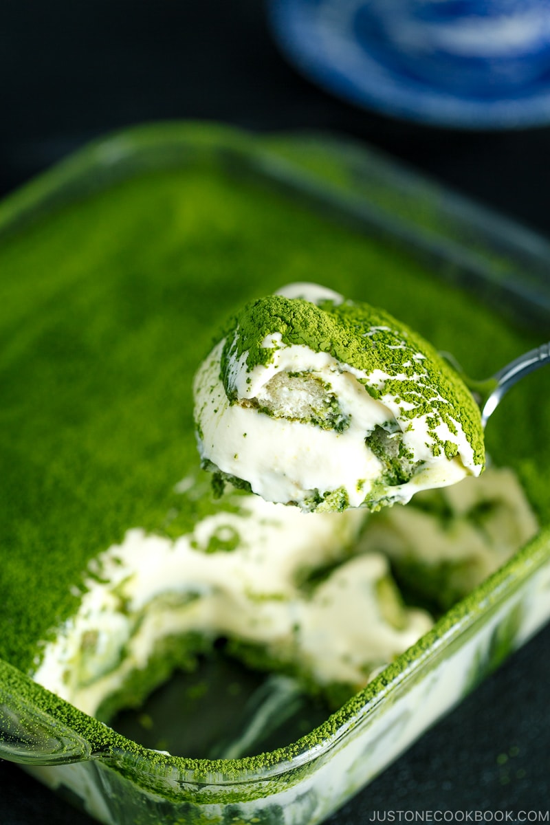 matcha tiramisu cake made with soaked ladyfingers and mascarpone custard filling.