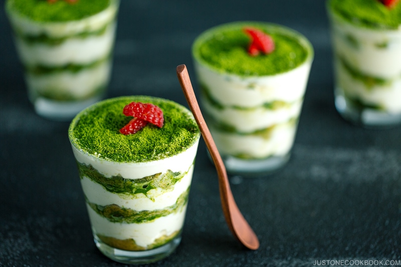 matcha tiramisu cake made with soaked ladyfingers and mascarpone custard filling.