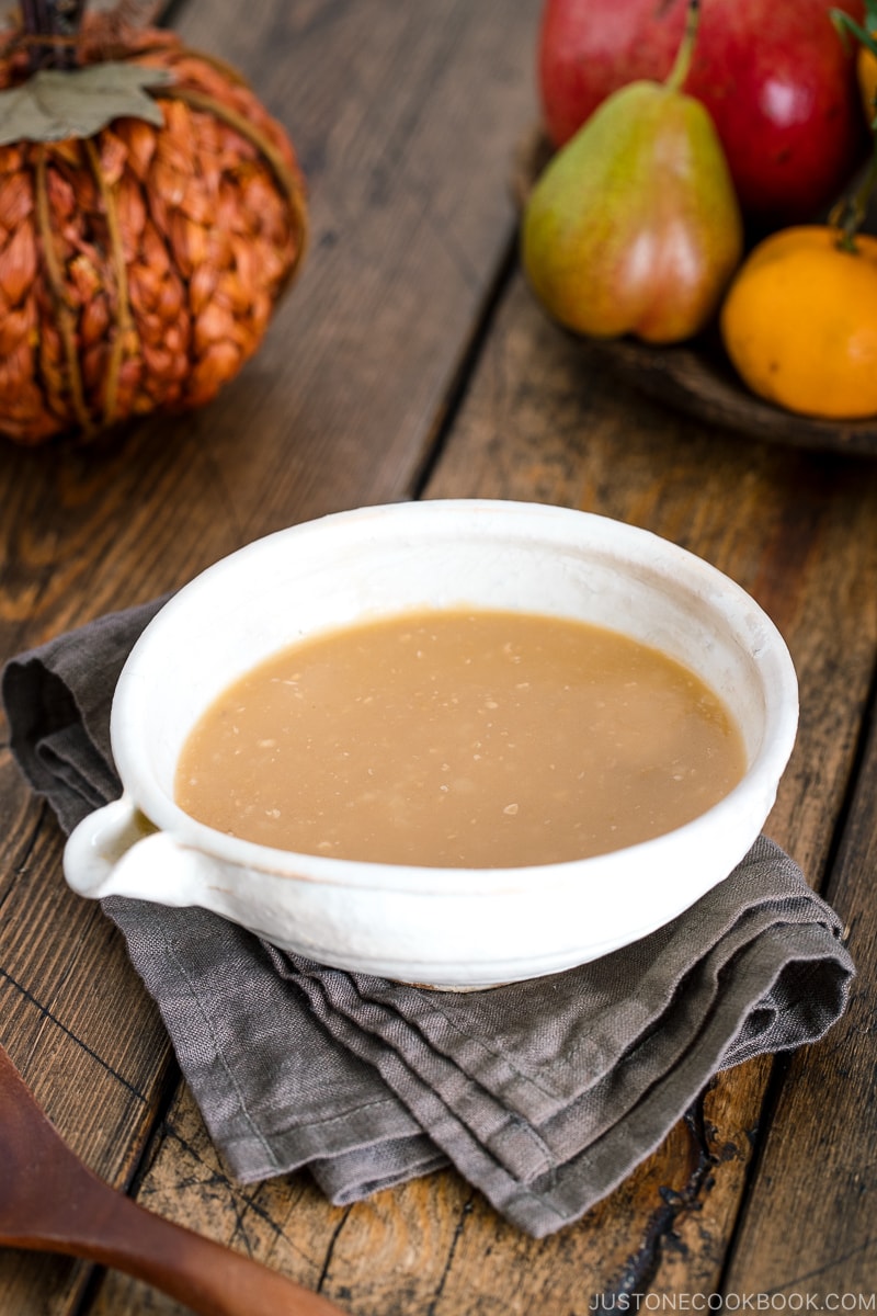 Miso butter gravy served in a white container.