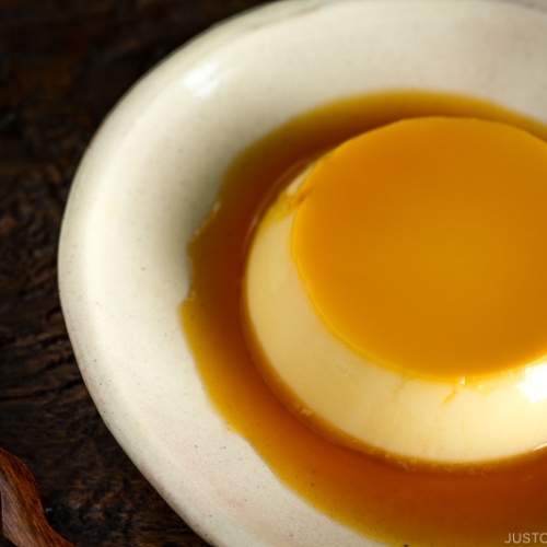 Creme caramel (flan) on a white plate.