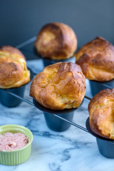 Popovers placed in the special popover pans along with strawberry butter.