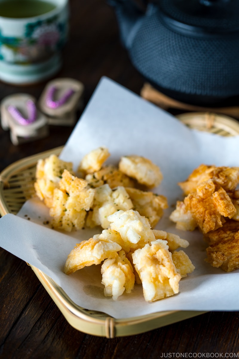 Rice crackers served on a bamboo basket.