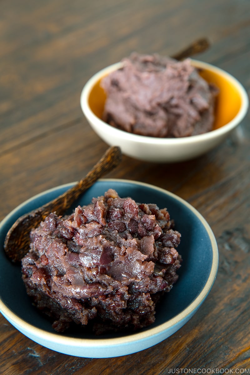 Two bowls containing fine and chunky sweet red bean paste (anko).