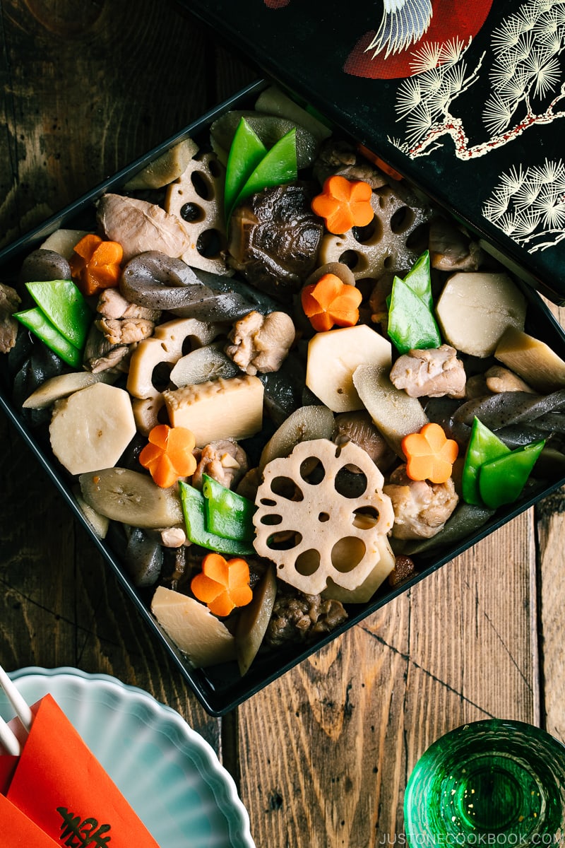 A lacquered box containing simmered chicken and vegetables.