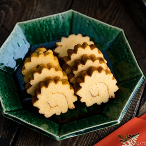 A green plate containing Datemaki, Japanese sweet rolled omelette, enjoyed during the New Years.