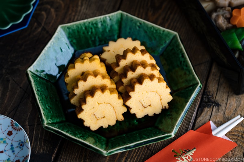 A green plate containing Datemaki, Japanese sweet rolled omelette, enjoyed during the New Years.