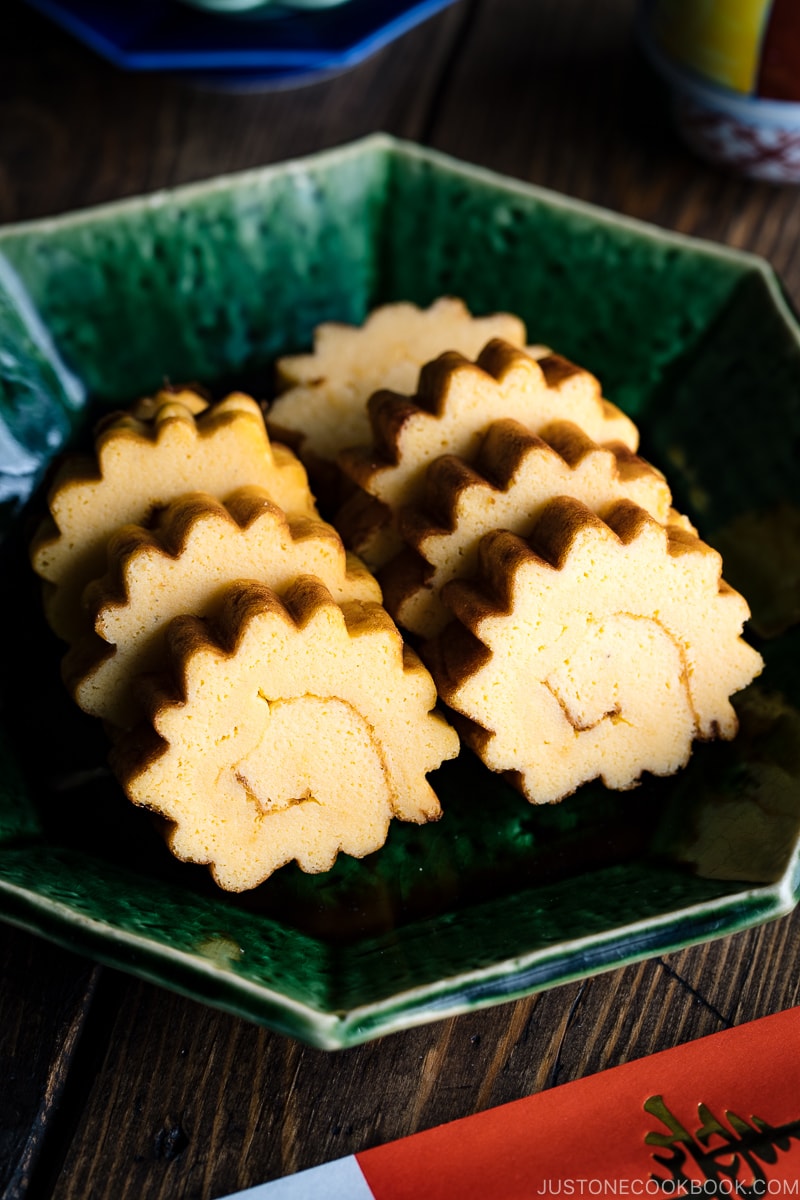 A green plate containing Datemaki, Japanese sweet rolled omelette, enjoyed during the New Years.