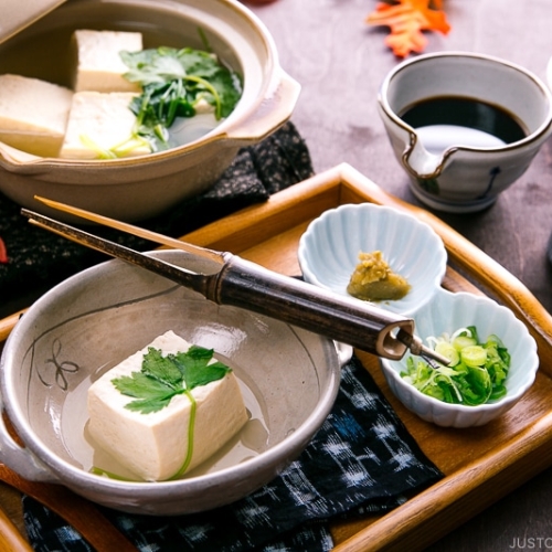 A Japanese ceramic bowl containing hot tofu.