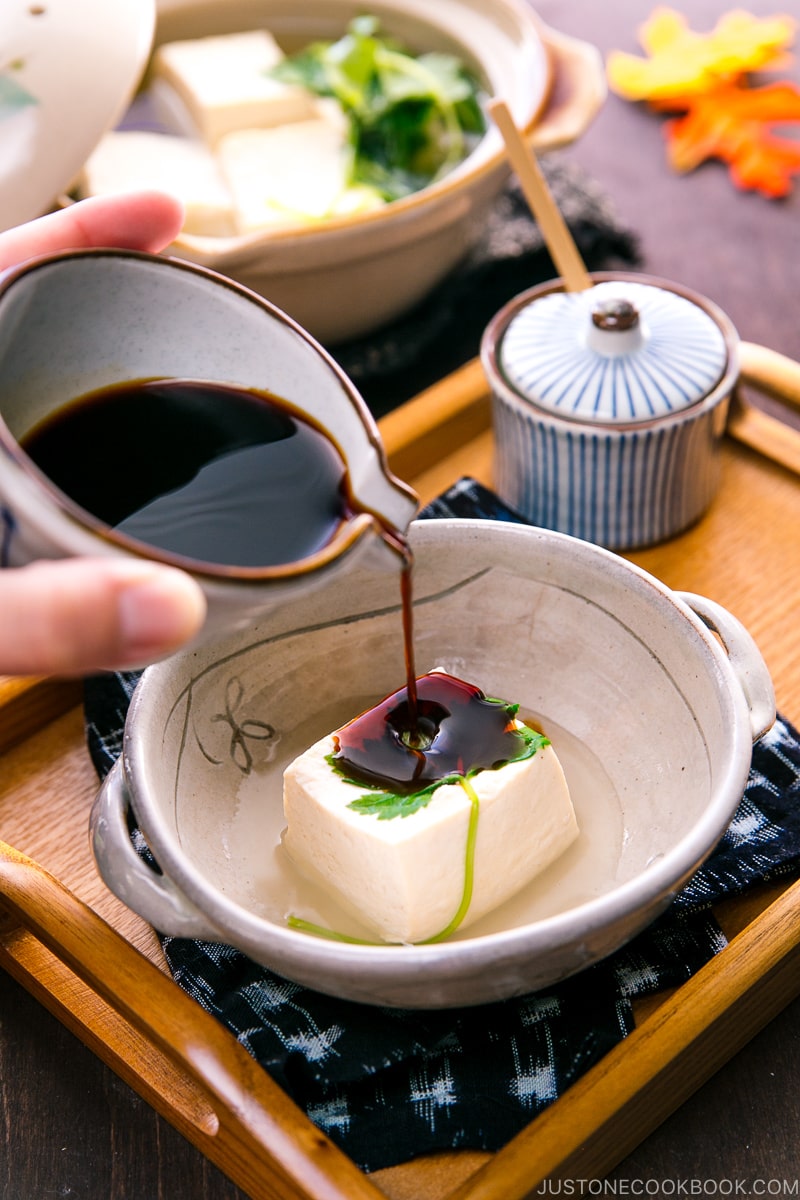 A Japanese ceramic bowl containing hot tofu.